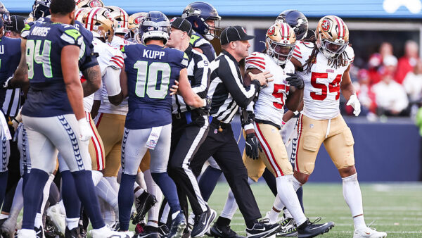 SEATTLE, WASHINGTON - OCTOBER 11: Dre Greenlaw #57 of the San Francisco 49ers is escorted away from the Seattle Seahawks sideline after a late hit on Sam Darnold #14 of the Seattle Seahawks (not pictured) during the second quarter at Lumen Field on October 11, 2026 in Seattle, Washington. (Photo by Olivia Vanni/Getty Images)