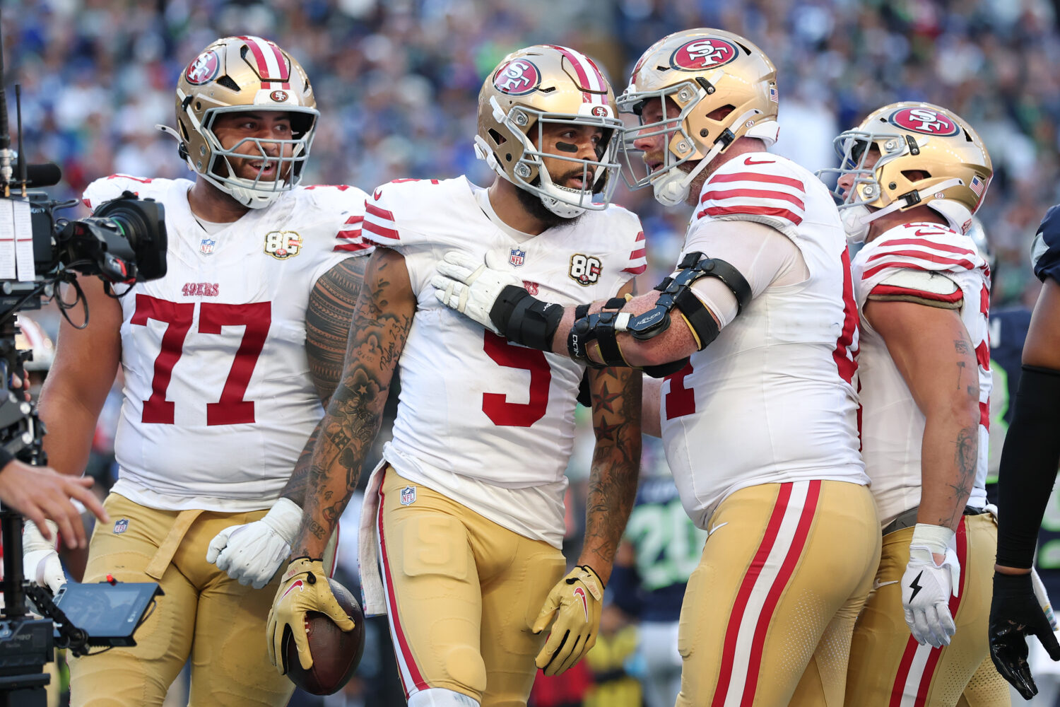 Mike Evans #5 of the San Francisco 49ers celebrates with Jake Brendel #64 after scoring a two-point...