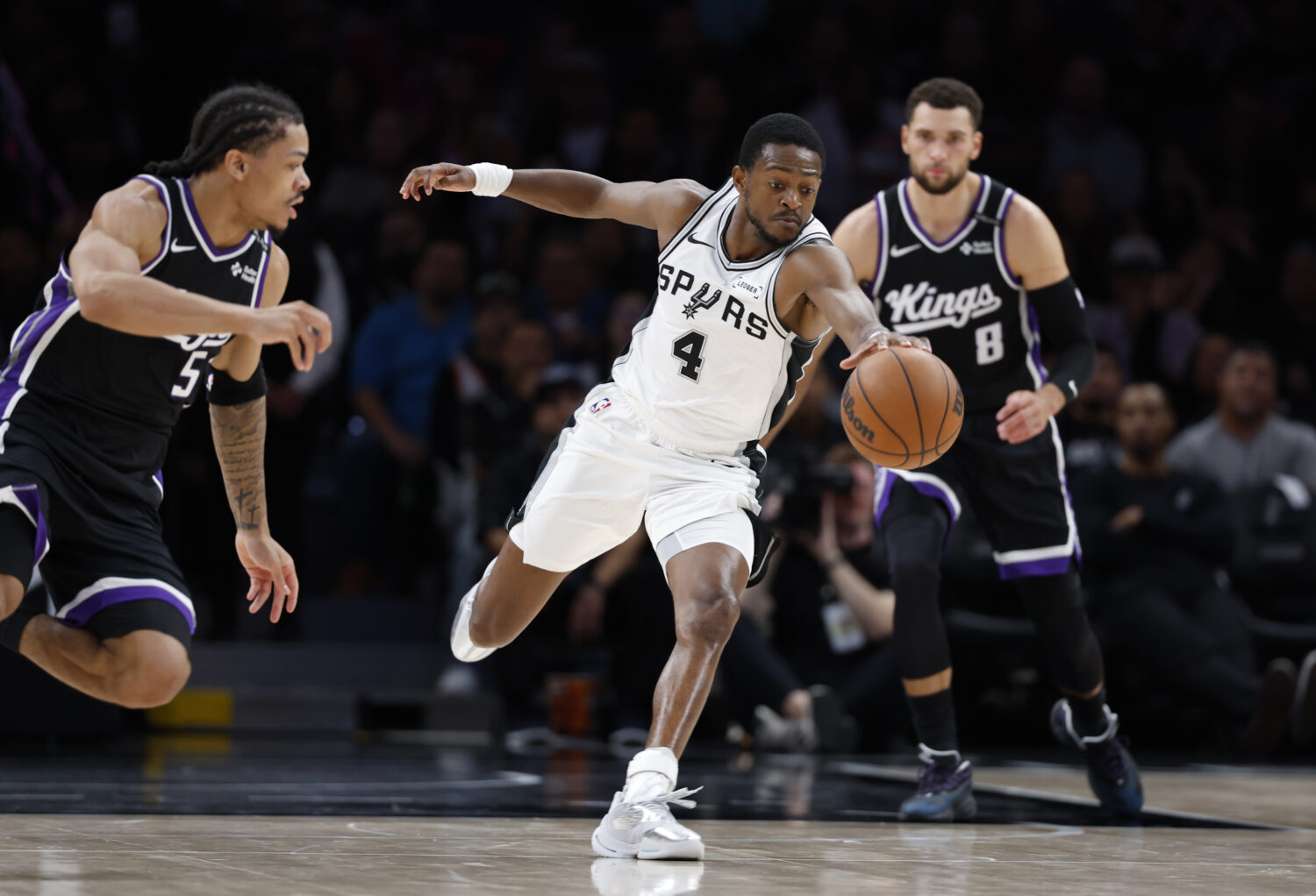 SAN ANTONIO, TX -OCTOBER 16: De'Aaron Fox #4 of the San Antonio Spurs goes for a loose bal against ...