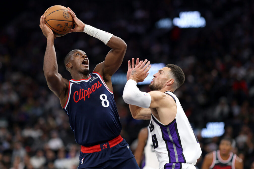 INGLEWOOD, CALIFORNIA - OCTOBER 21: Kris Dunn #8 of the Los Angeles Clippers shoots the ball against Zach LaVine #8 of the Sacramento Kings during the second quarter at Intuit Dome on October 21, 2026 in Inglewood, California. NOTE TO USER: User expressly acknowledges and agrees that, by downloading and or using this photograph, user is consenting to the terms and conditions of the Getty Images License Agreement. (Photo by Luke Hales/Getty Images)