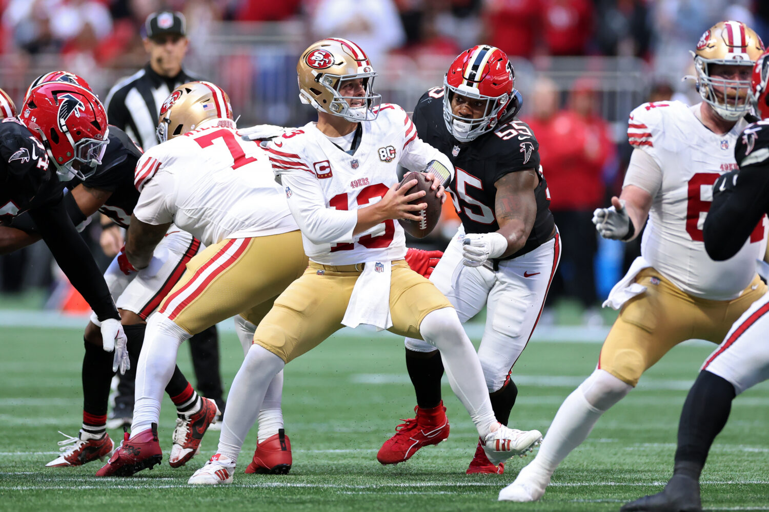 ATLANTA, GEORGIA - OCTOBER 25: Brock Purdy #13 of the San Francisco 49ers scrambles with the ball u...